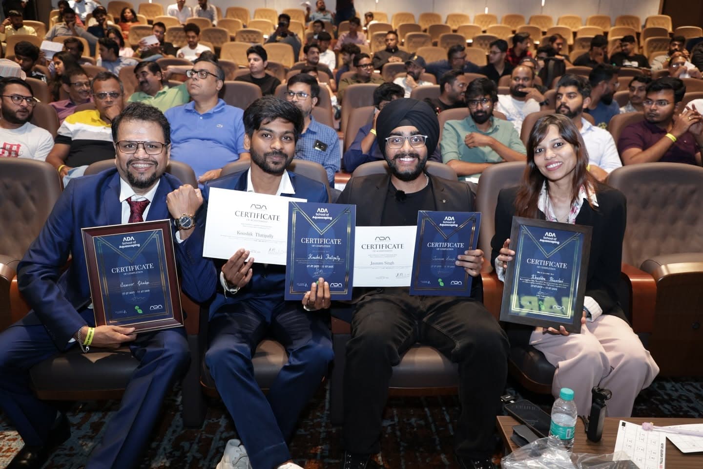 Finalists holding their certificates in the audience
