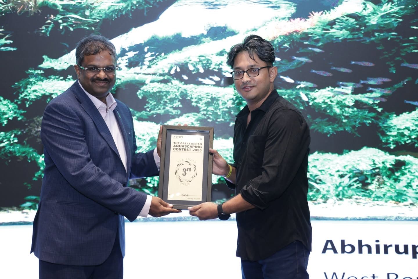 Third place award being presented on stage